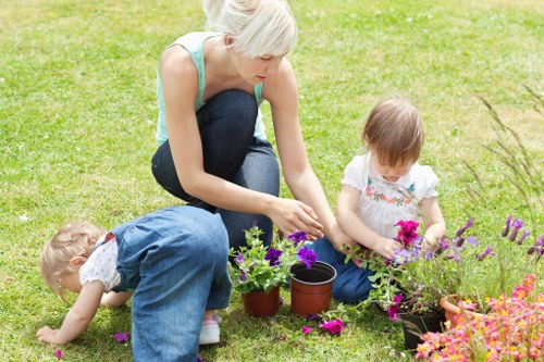 Gardener watering plants in a well-maintained Camberwell garden
